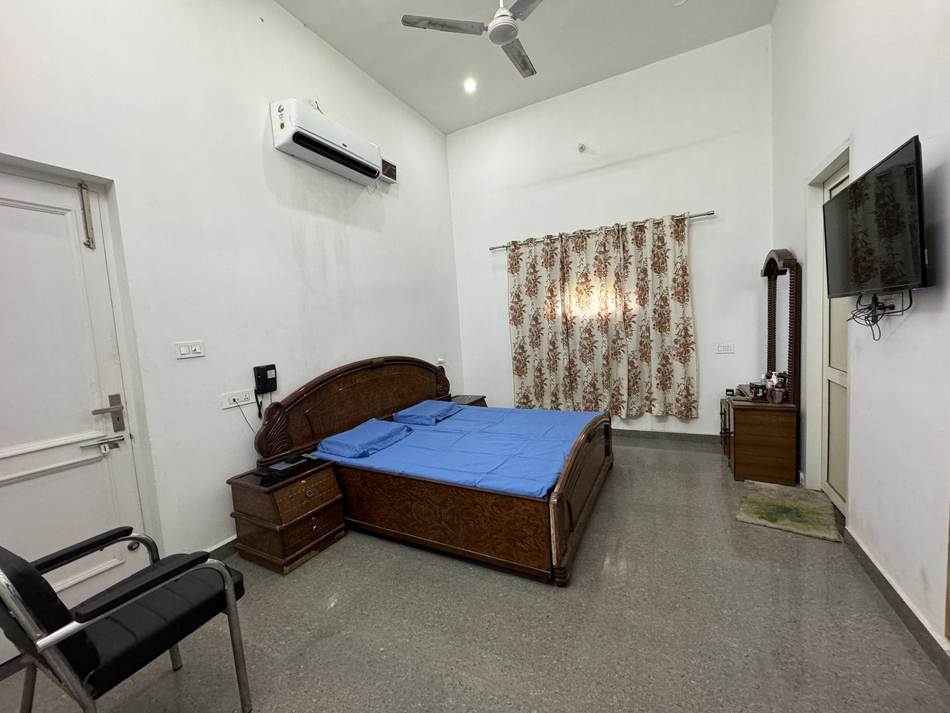A private room with bed and television